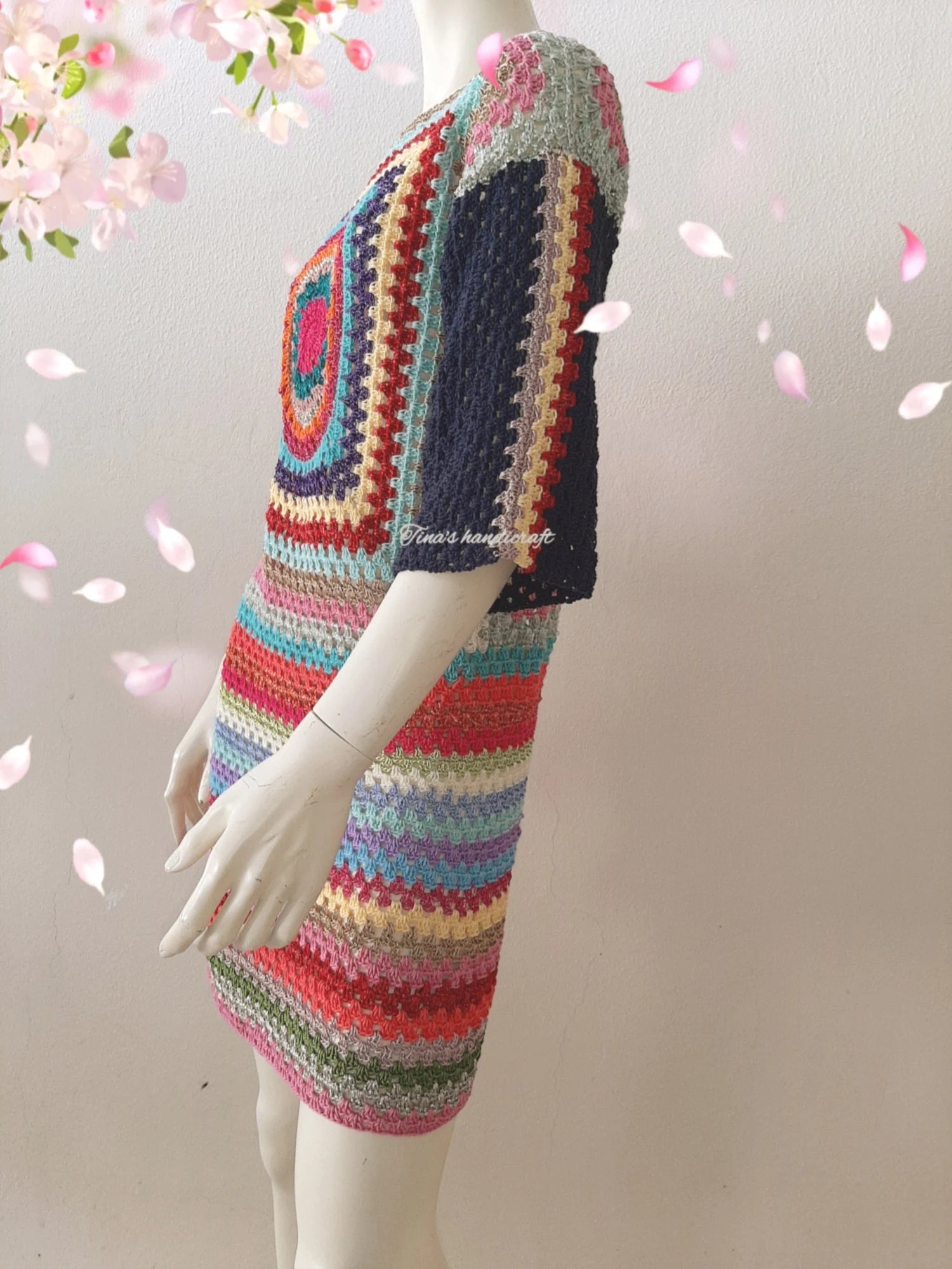 Mini length crochet dress with 3/4 sleeves. The colorful pattern and combination of fabrics make it unique."